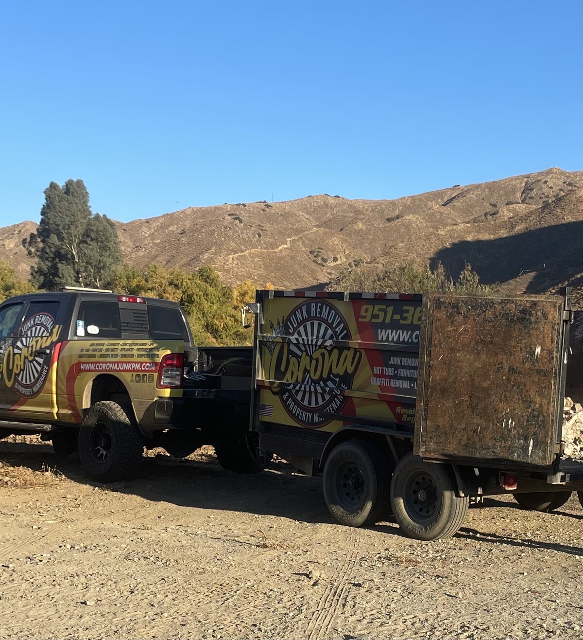 Temescal Valley Junk Removal branded truck and dump trailer parked against the Temescal Valley mountains